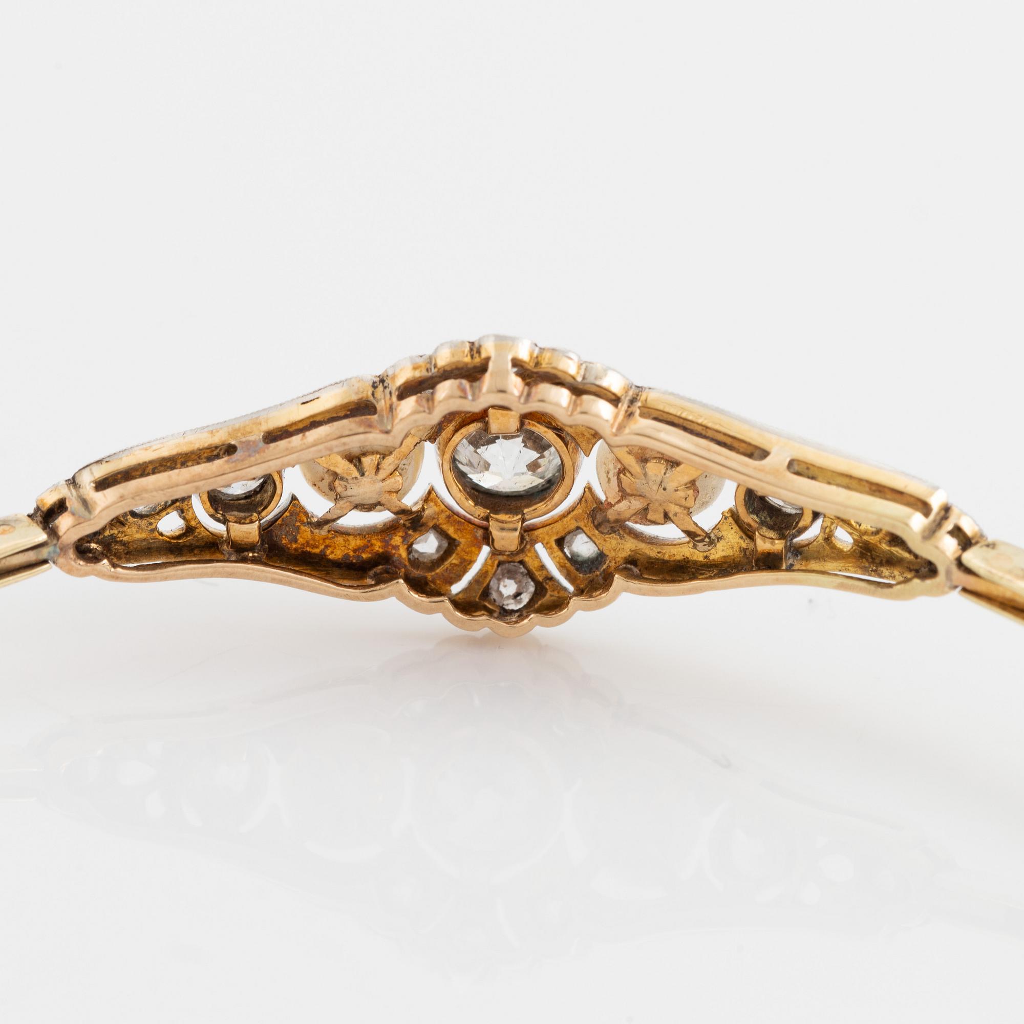 A 14K gold and platinum bracelet set with old- and rose-cut diamonds and pearls.