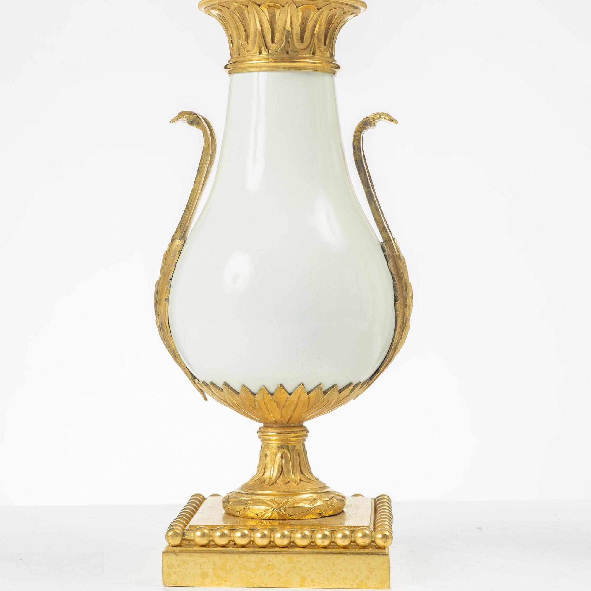 A pair of three light porcelain and gilt bronze three-branch Louis XV-style candelabra, mid 19th century.