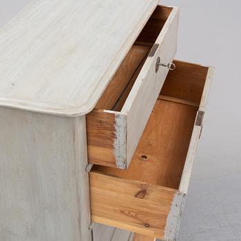 A painted chest of drawers from around the year 1900.