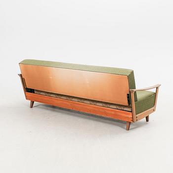 A 1960s teak sofa bed.