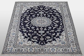 A carpet, Nain, part silk, ca 310 x 205 cm.