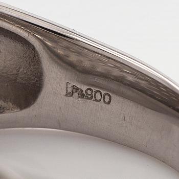 A platinum bombé ring with brilliant-cut diamonds.