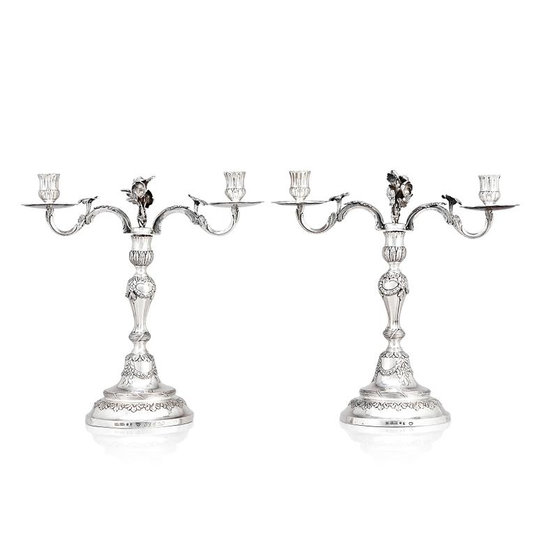 A pair of Swedish 18 century silver candelabras, mark of Lars Åkerblom Gävle 1775, arms by Christian Kullberg.