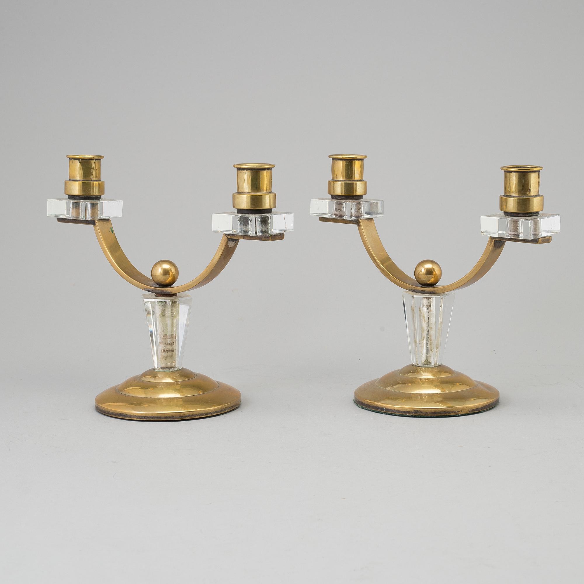 A pair of art déco brass and glass candelabra.