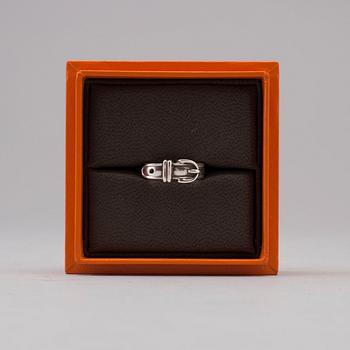 A silver ring by Hermès.