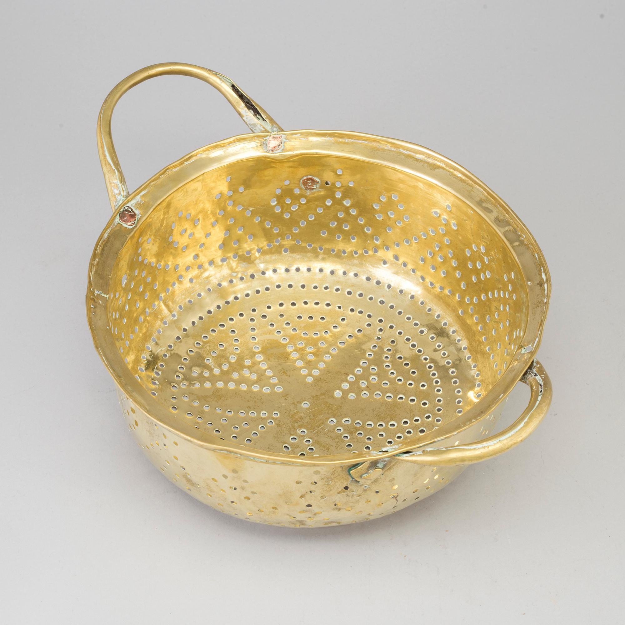 A 19th century brass colander.