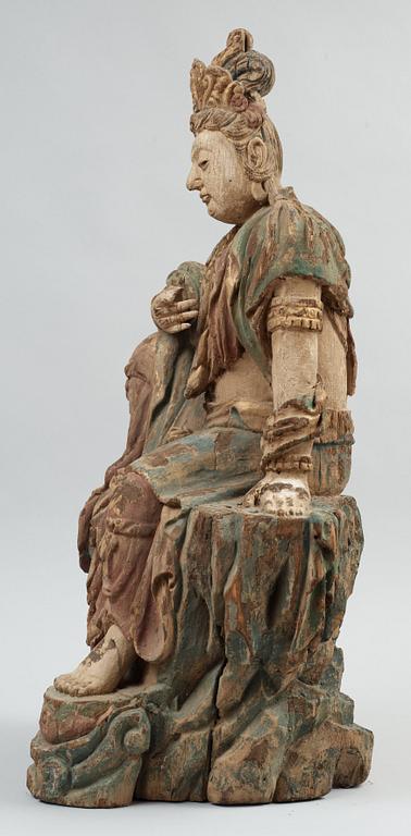 A seated wooden figure of Guanyin, presumably Ming dynasty (1368-1644).