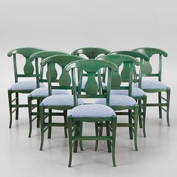 A dining table with eight chairs, Grange, France, late 20th century.
