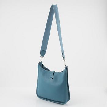 Hermès, A blue Taurillon Clemence leather Evelyn bag, 2008.