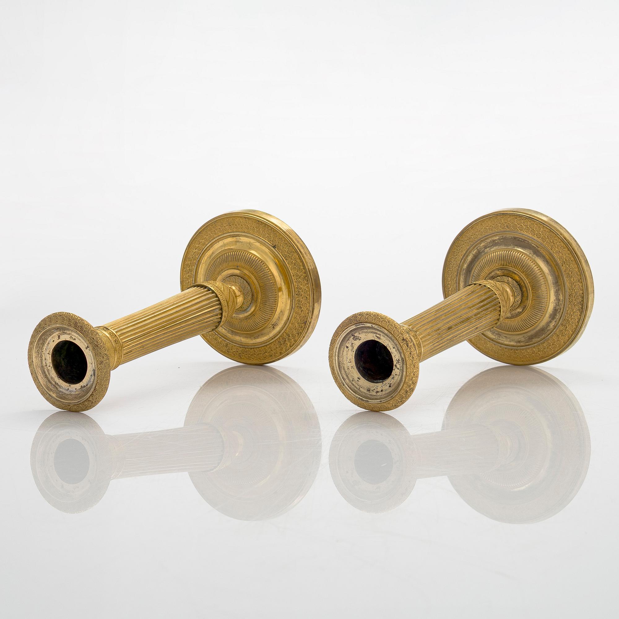 A pair of French gilded Empire candlesticks, early 19th century.