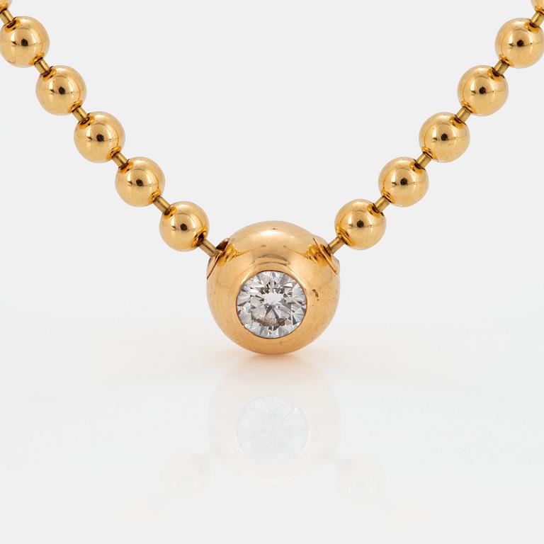 A Cartier "Pluie de Diamants" 18K gold necklace with a round brilliant-cut diamond.