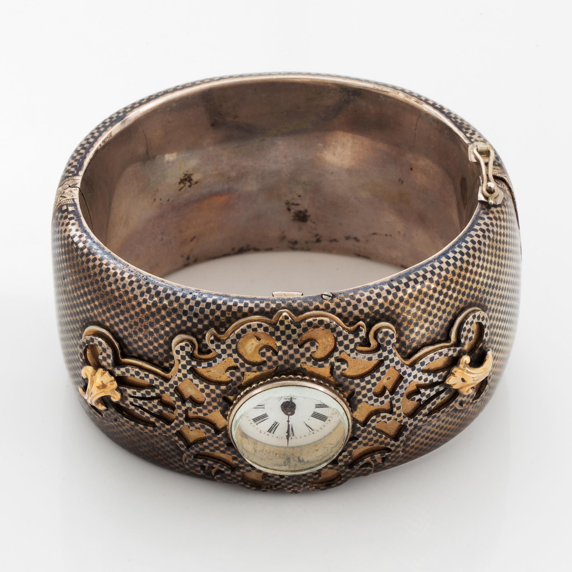 Silver bangle with watch.