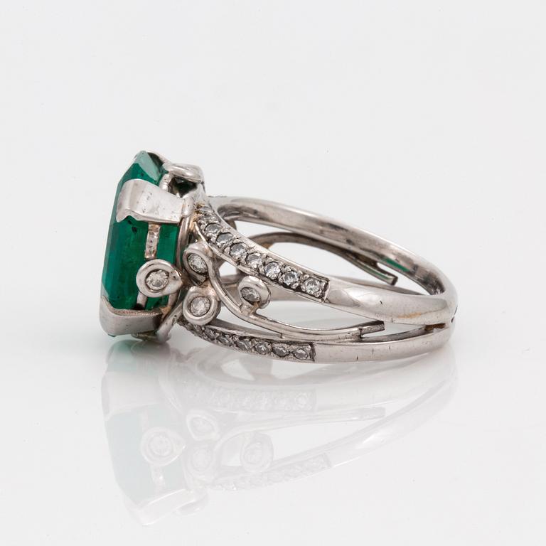 An octagonal cut 6.50 ct emerald and brilliant cut diamond ring. Mandelstam 'Ice Age'.
