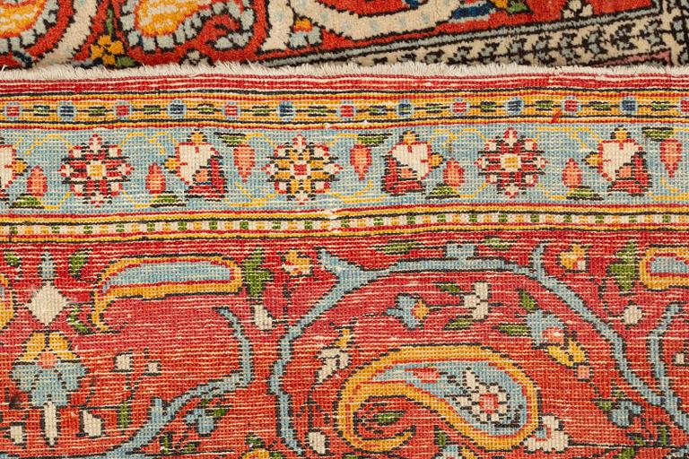 A carpet, semi-antique, Qum, ca 318 x 233 cm.