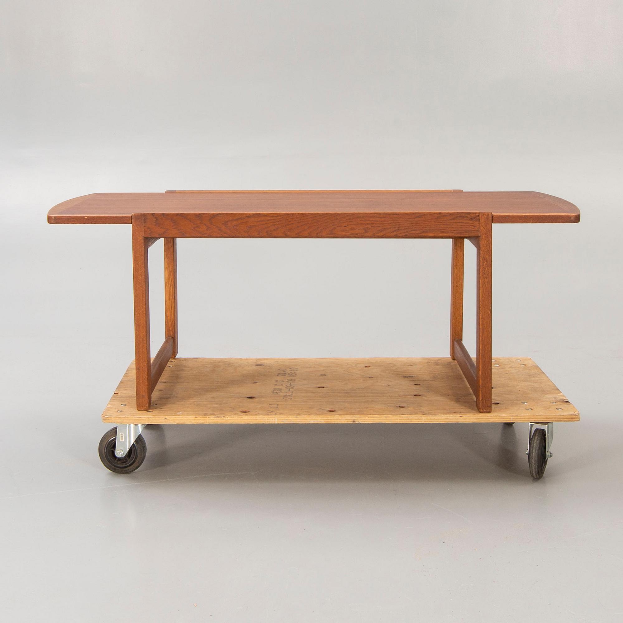 A 1960s, probably Danish teak and oak coffee table.
