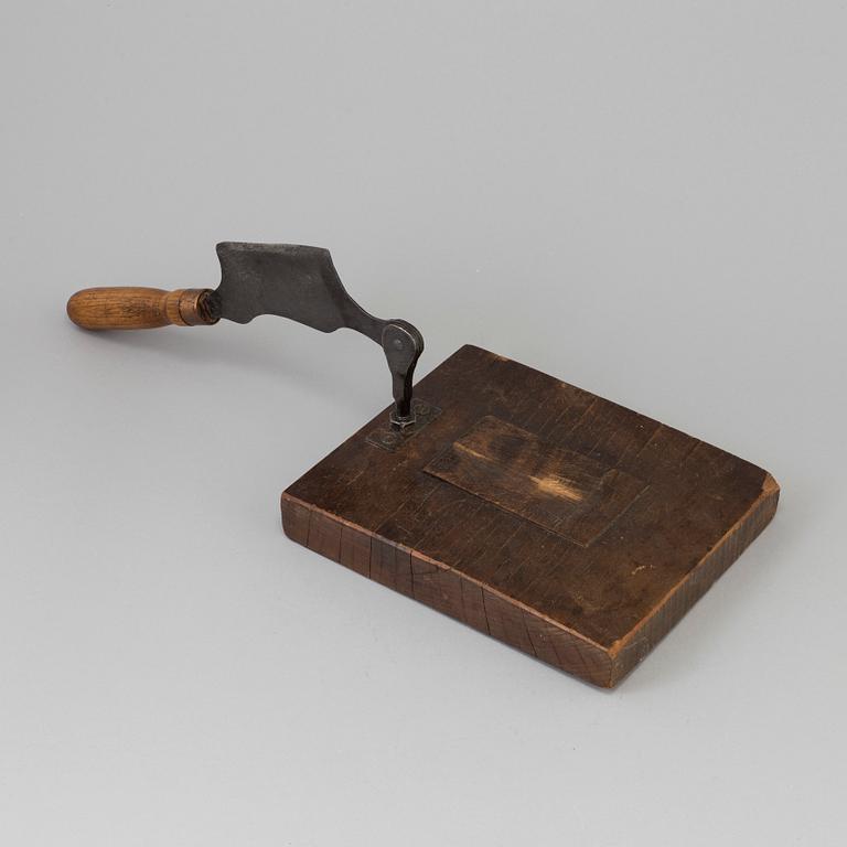 A 19TH CENTURY TOBACCO CUTTER, wood and iron.