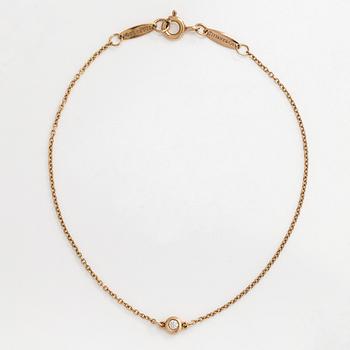 Tiffany & Co, an 18K gold 'Diamonds by the Yard' bracelet with a brilliant-cut diamond.