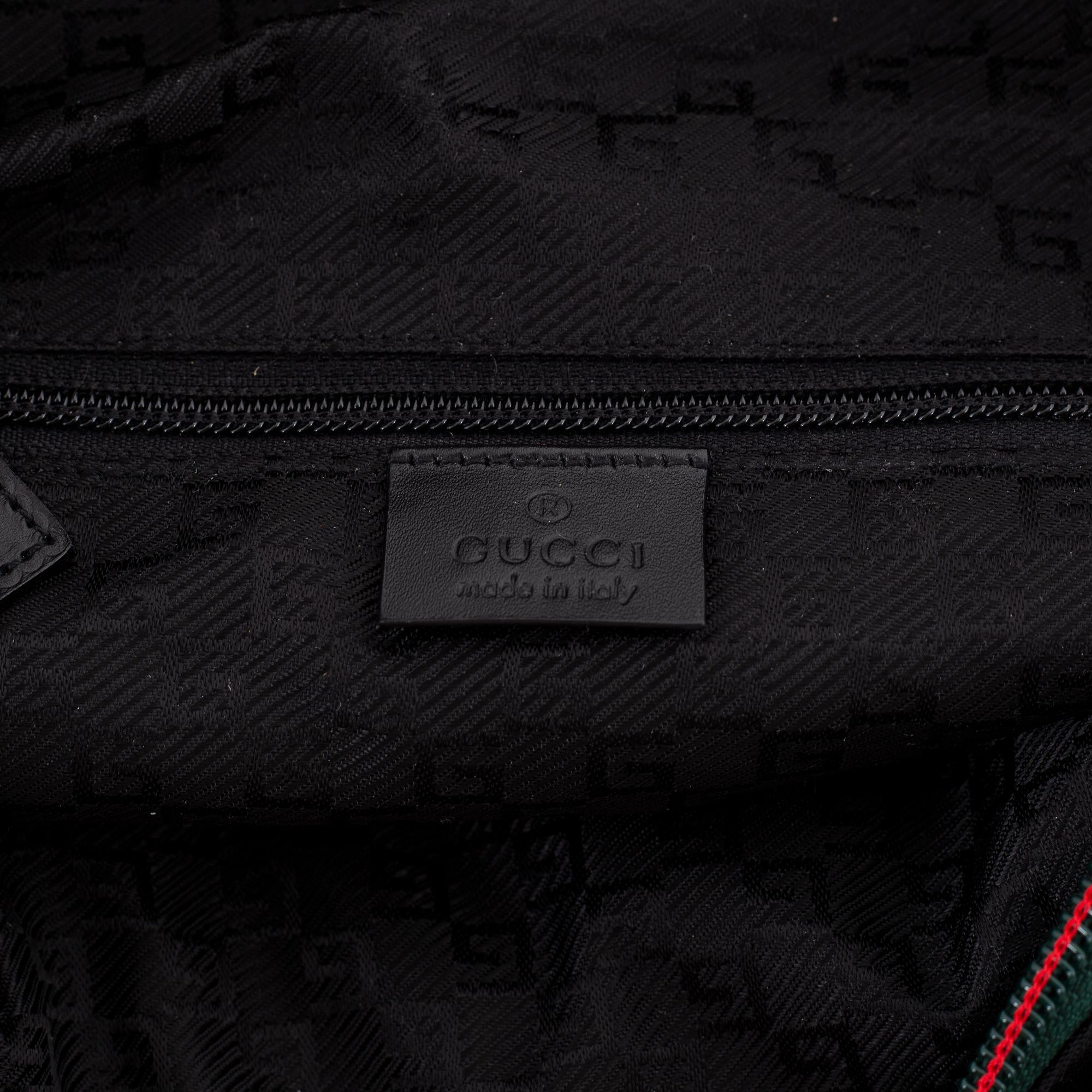 Gucci, a black canvas backpack.