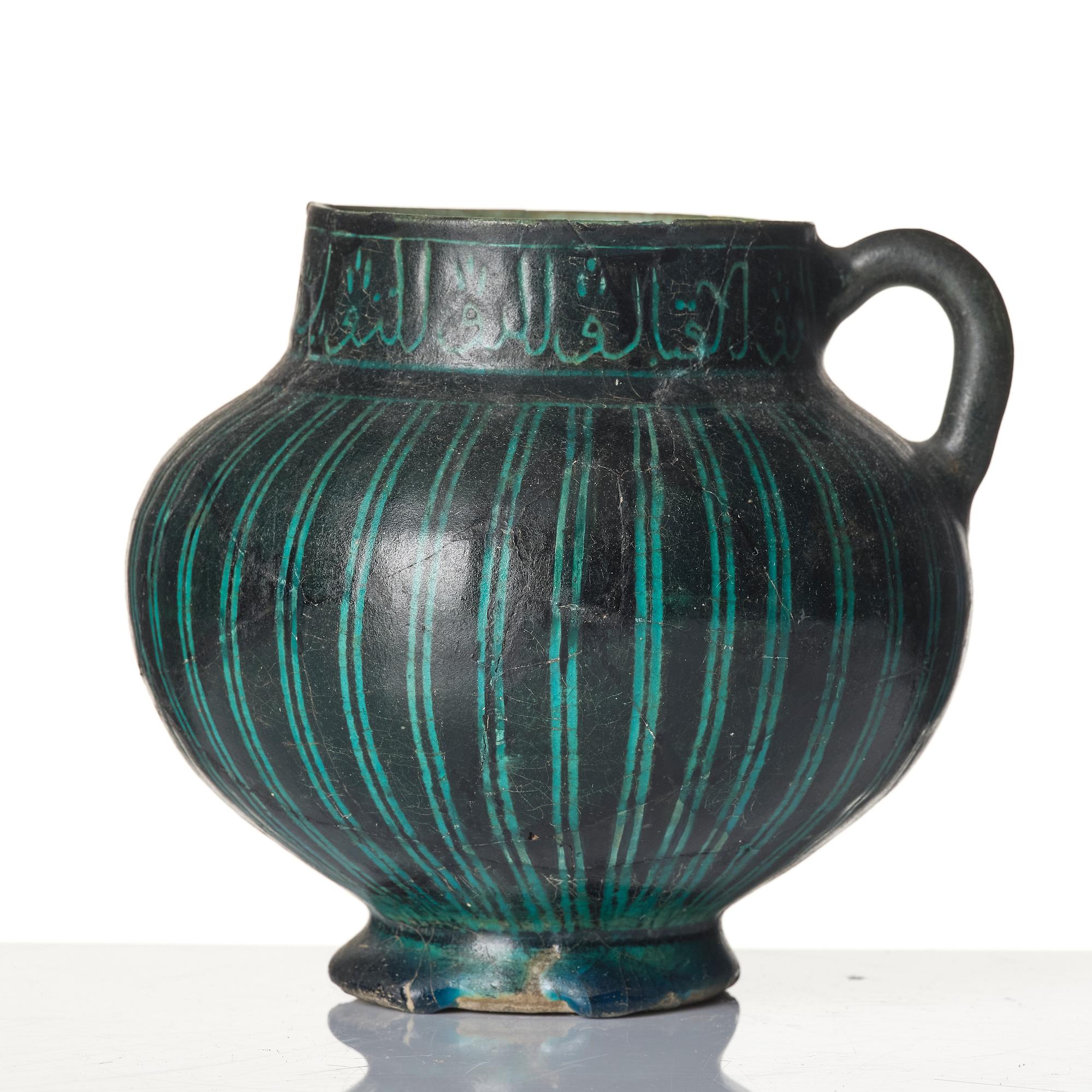 A Kashan Silhouette ware turquoise glazed pottery jug, central Iran, circa 1200.
