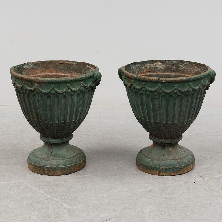 A pair of early 20th century iron garden urns.