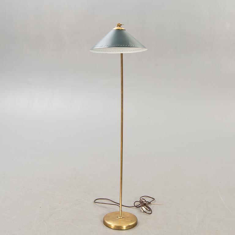 A 1950s brass floor lamp.