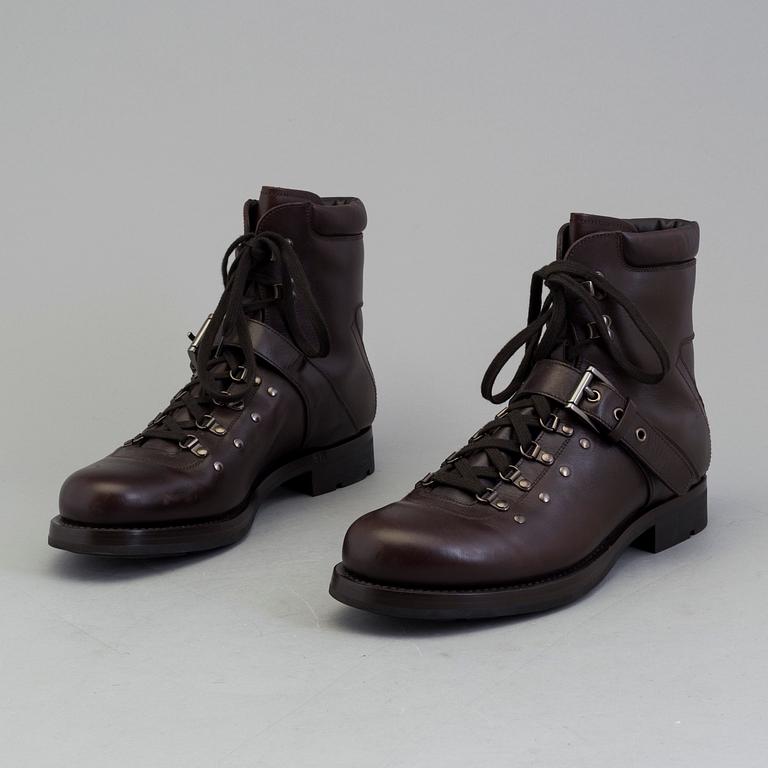 A pair of darkbrown leather boots by Prada.