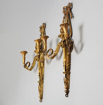 A pair of Louis XVI style brass wall sconces, first half of the 20th Century.