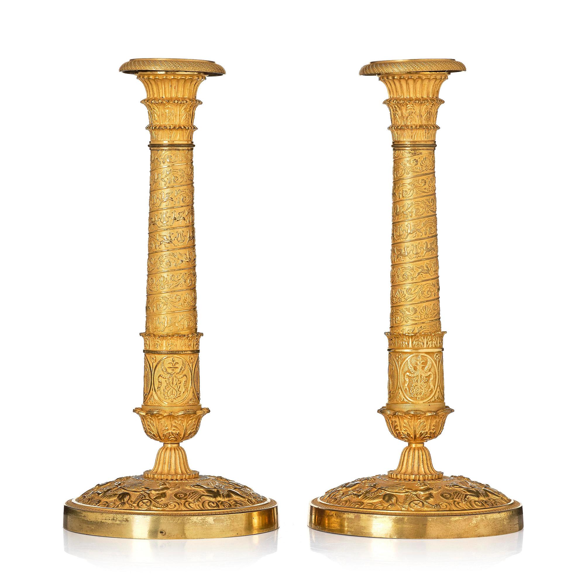 A pair of French Empire ormolu candlesticks, Paris, early 19th century.