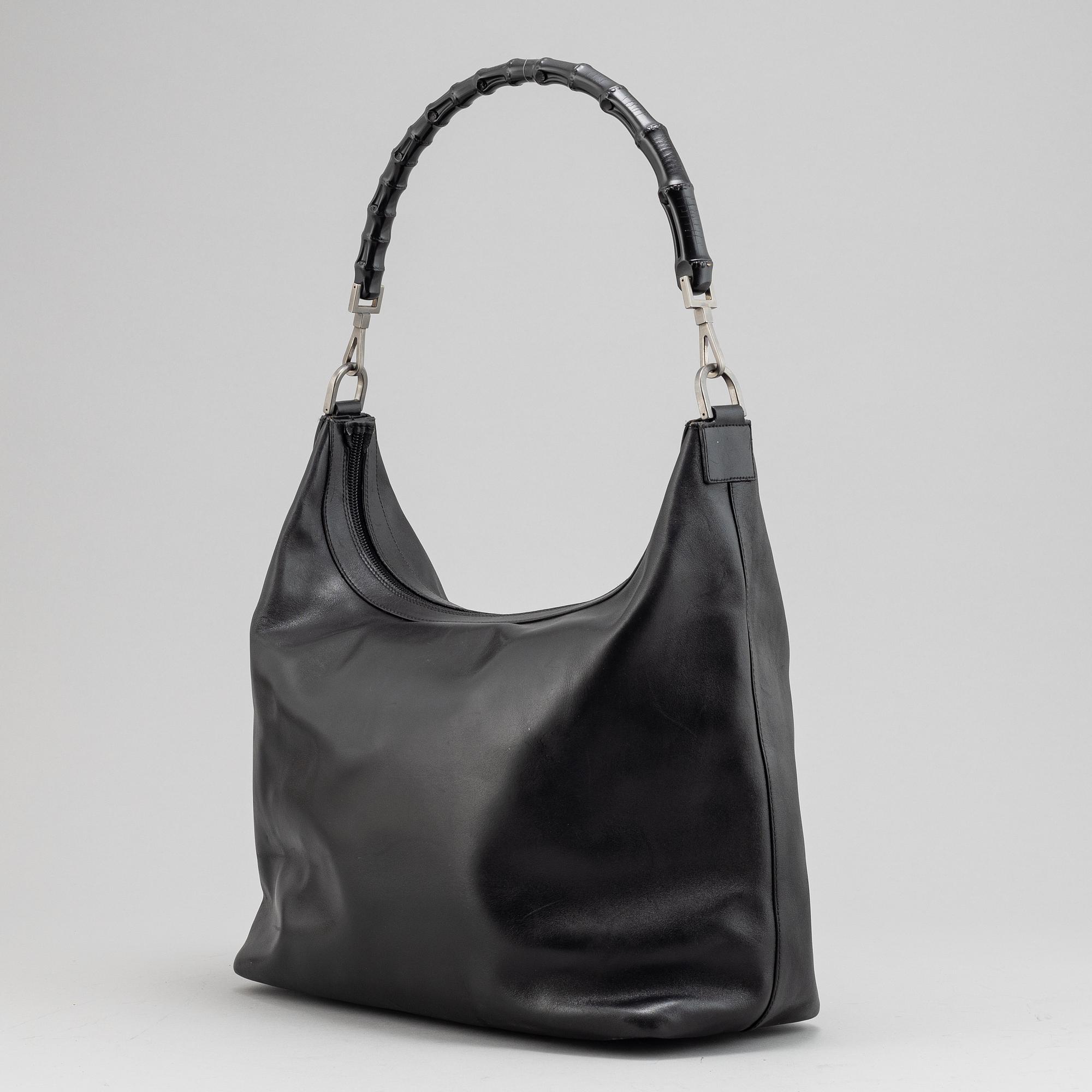 Gucci, a black leather handbag.