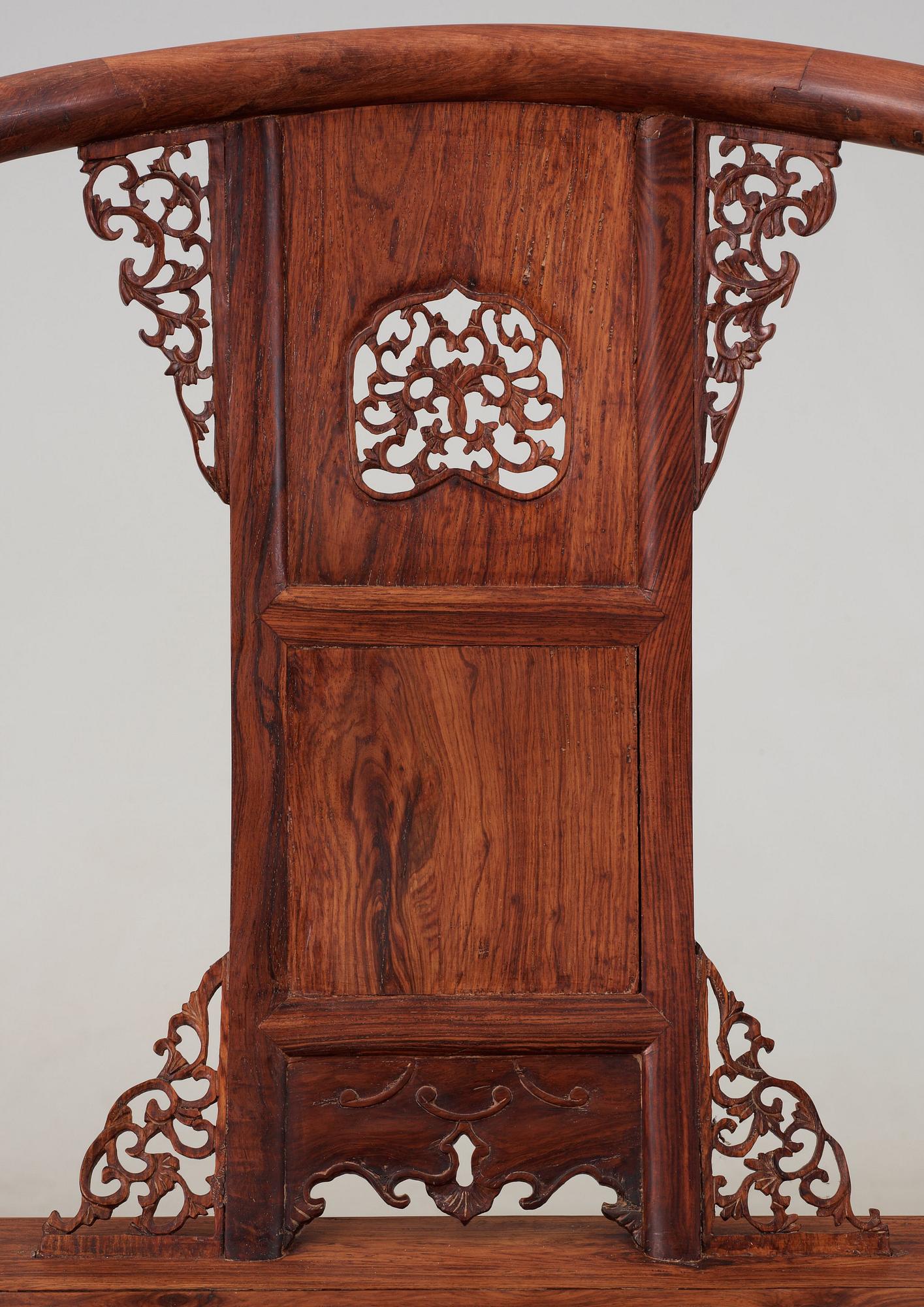 A pair of hardwood horseshoeback armchairs, late Qing dynasty, circa 1900.