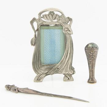 Photoframe, letter opener and seal, Art Nouveau, early 20th century, pewter and nickel silver.