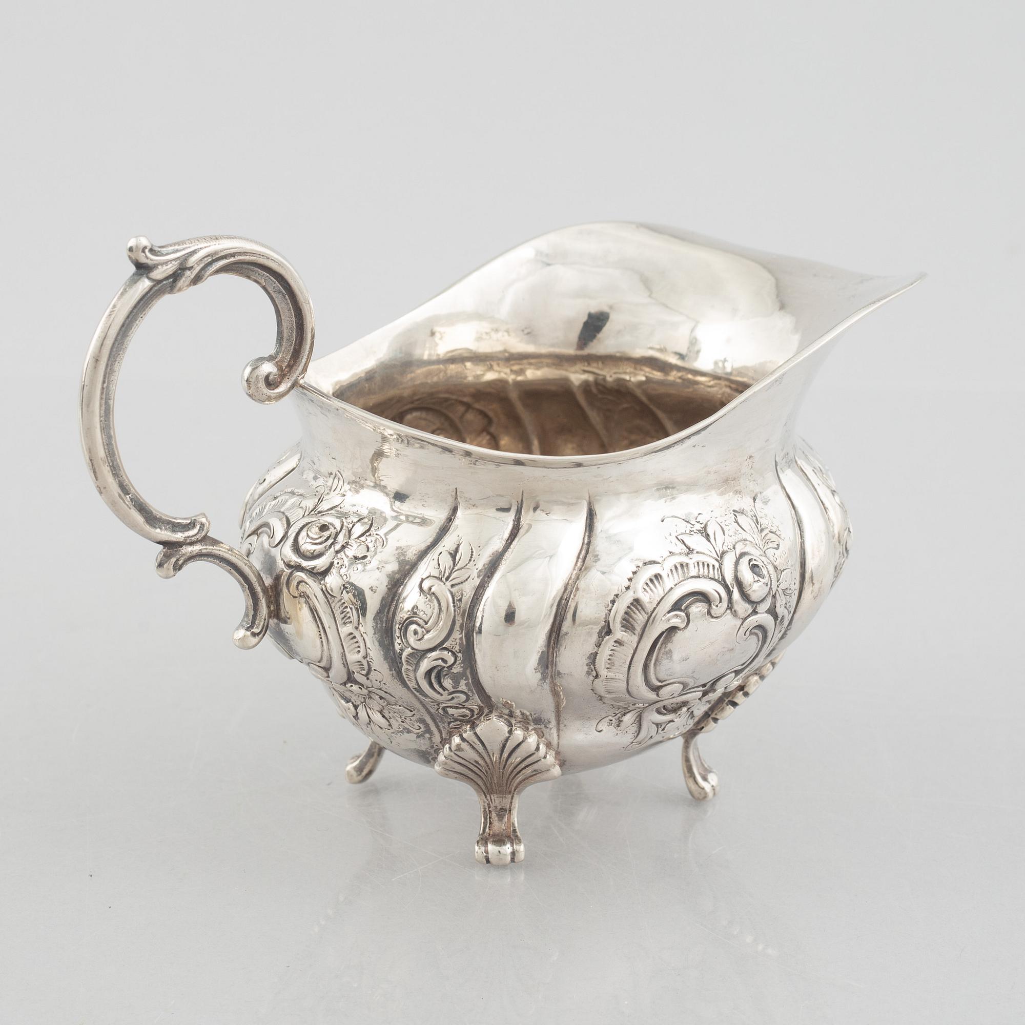 A Rococo-style silver coffee pot, creamer and sugar bowl, 20th Century.