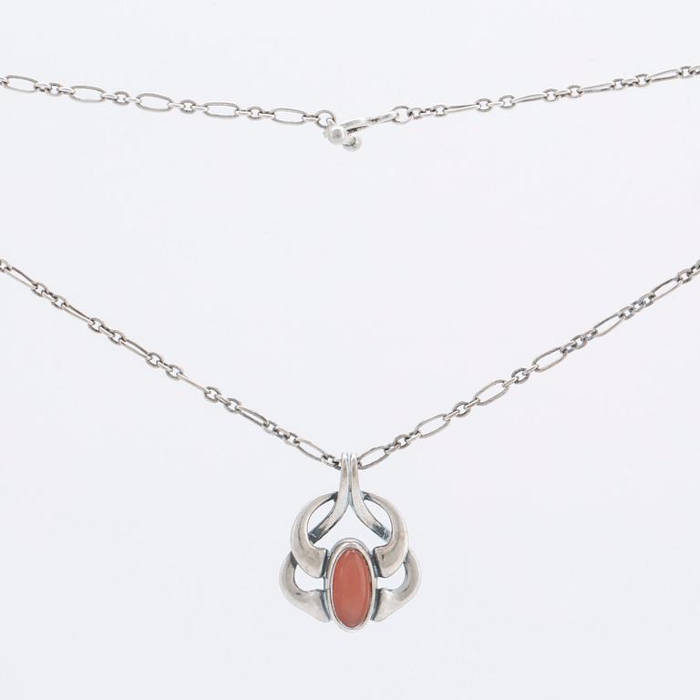 A silver and moonstone jewellery set consisting of necklace and earrings by Georg Jensen, jewellery of the year 2006.