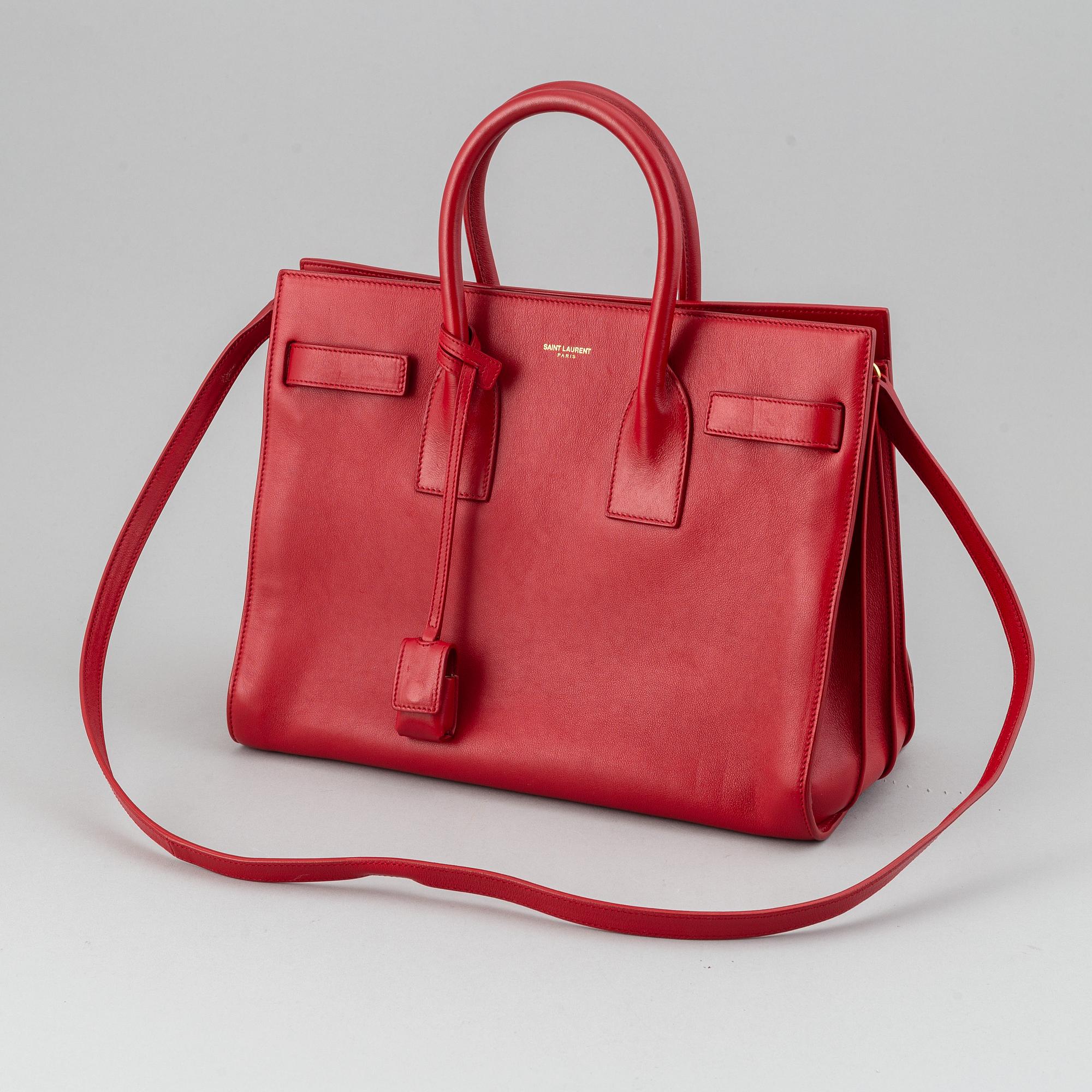Saint Laurent, a red leather 'Sac du Jour Small' bag.
