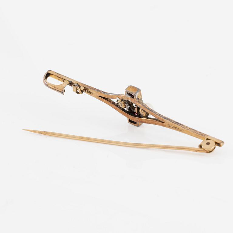 Brooch, 14K gold with a small old-cut diamond, pearls, and red stones.