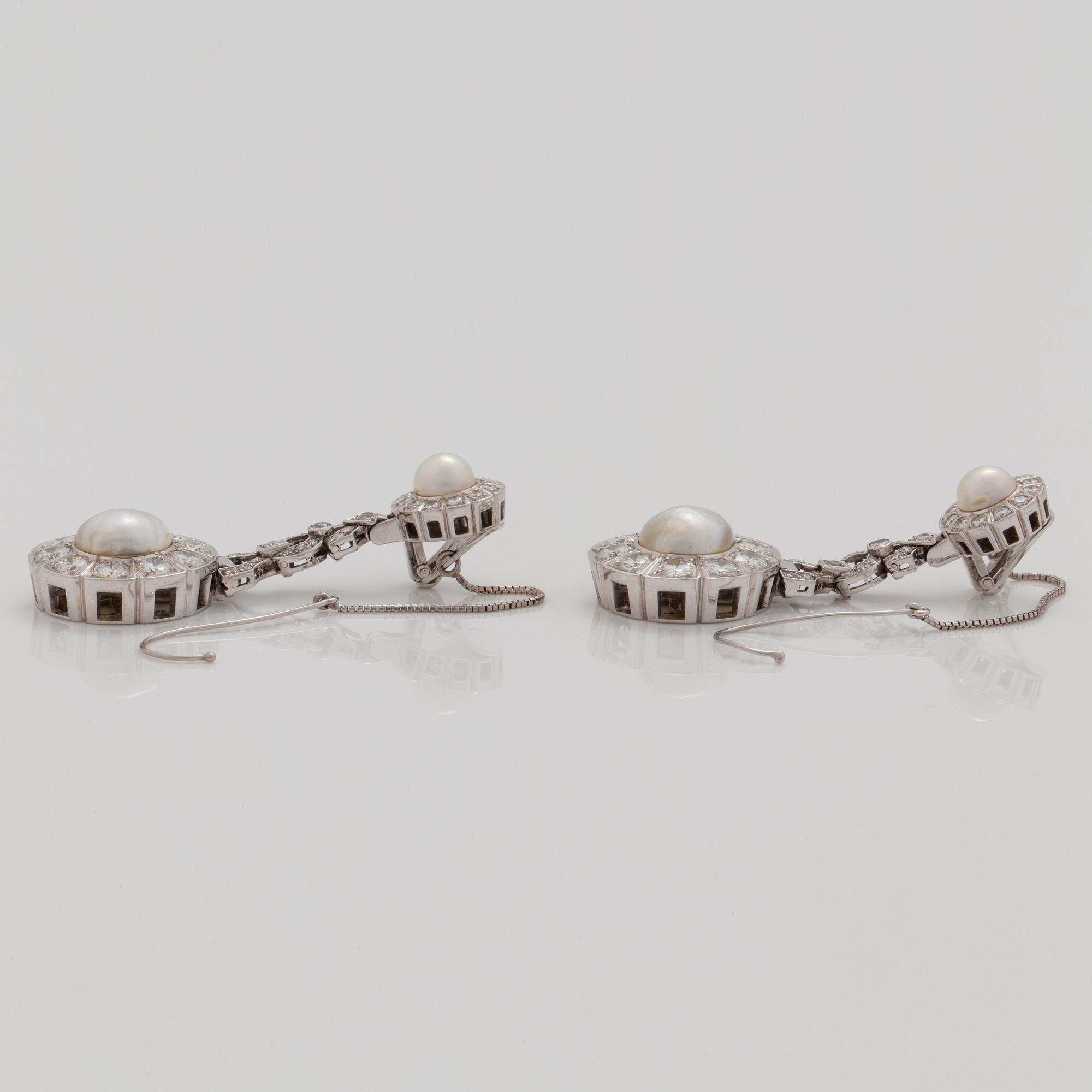 A pair of probably natural saltwater pearl, cultured pearl and brilliant cut diamond earrings.
