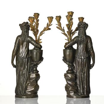 A pair of Louis XVI-style four-light gilt and patinated bronze candelabra after Clodion, later part 18th century.