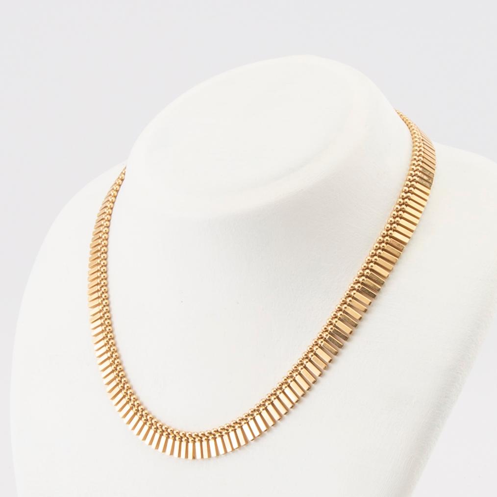 An 18K gold necklace by Unoaerre Italy.