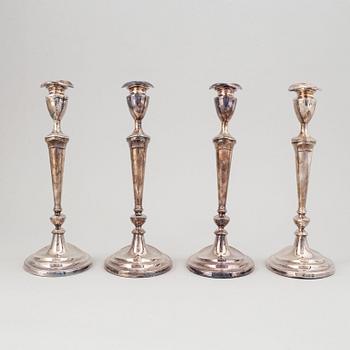 A set of four English 19th century silver-plated candlesticks.
