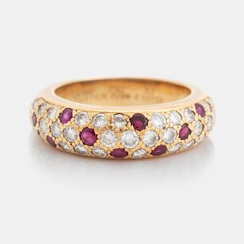 An 18K gold Cartier ring set with round brilliant-cut diamonds and rubies.