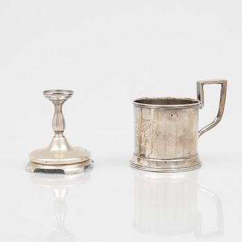 A Russian Silver Candlestick, 1908-26, and a Russian Silver Tea Glass Holder, assay master A. Skovronsky, Moscow 1896.