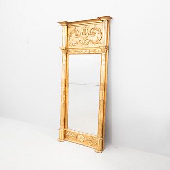 A kid 1800s gilded Empire mirror.