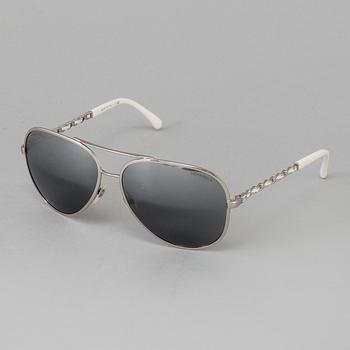 A pair of sunglasses by Chanel.