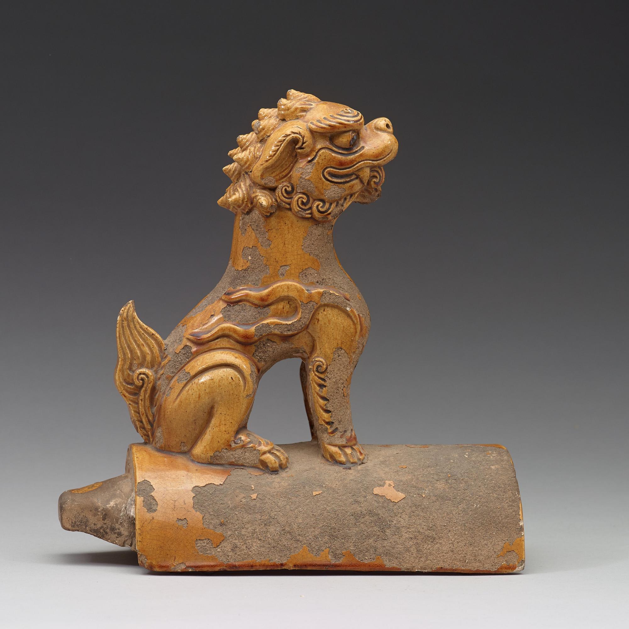 A yellow glazed roof tile figure of a Buddhist lion, Ming dynasty (1368-1644).