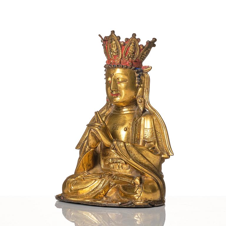 A gilt-bronze figure of Vairochana, Ming dynasty (1638-1644).