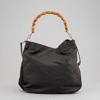 Gucci, a chocolate brown nylon handbag.