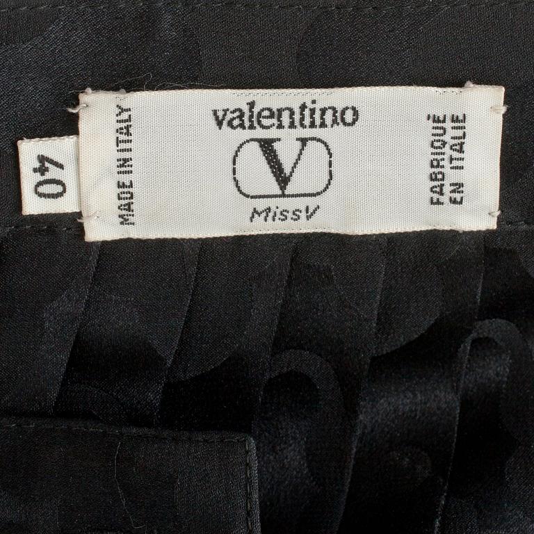 VALENTINO, a black silk skirt.
