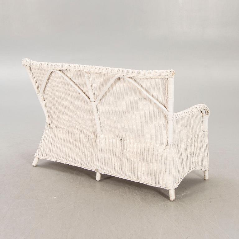 An Artwood rattan sofa.