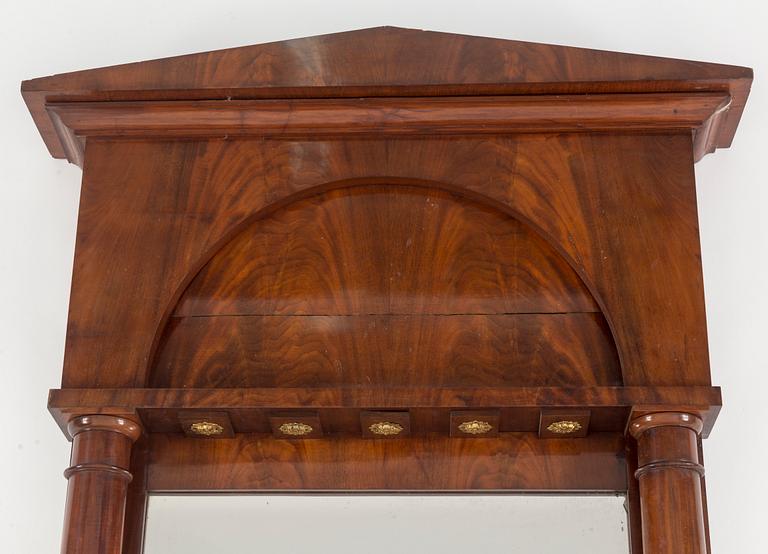 A first half of the 19th century mahogany veneered mirror.