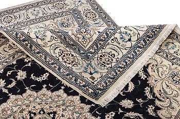A Nain carpet, part silk, c. 303 x 200 cm.